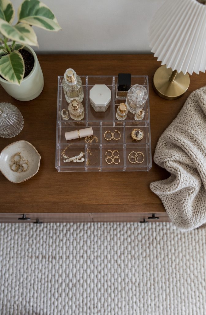 10 Bedroom Dresser Ideas for Every Style 6 An organizer on a dresser holding daily essentials like perfumes.