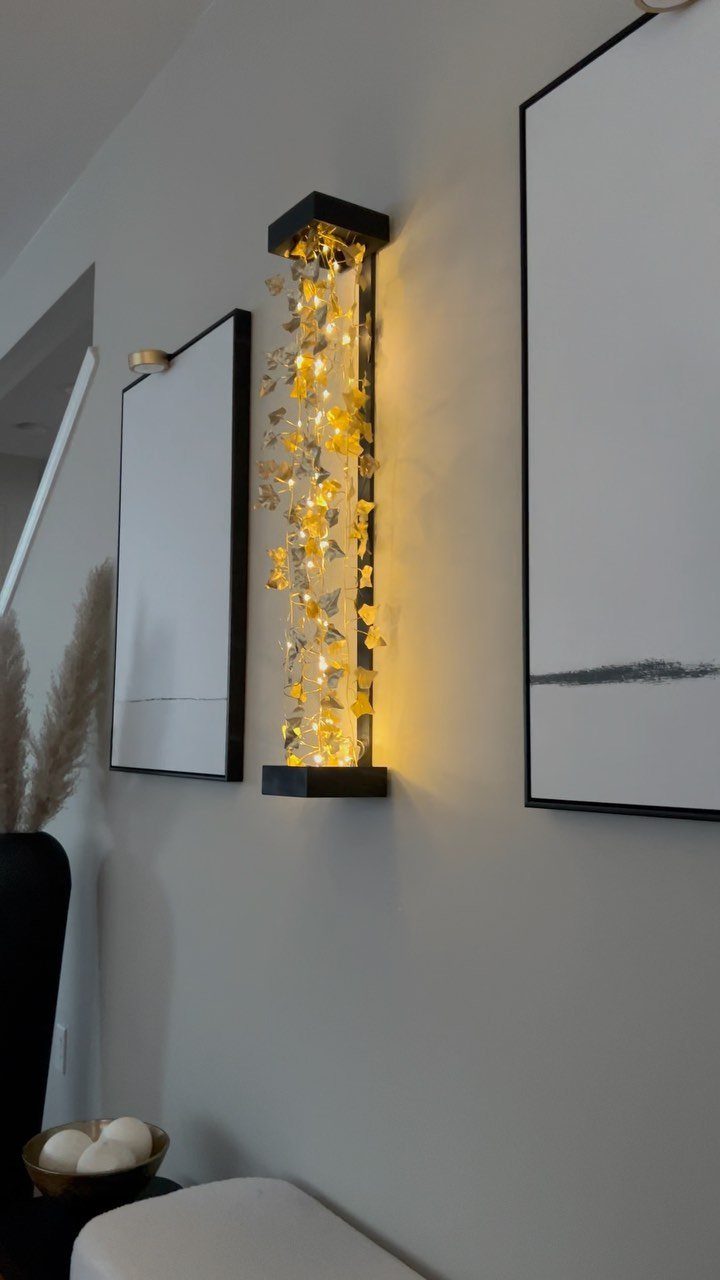 DIY LED Light Lamp Ideas: 27 Backlights, Pendants, Table Lamps 13 Vertical wall lamp with warm LED lights and yellow flowers in a black frame.