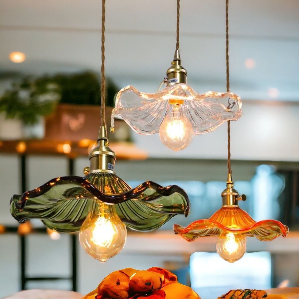 DIY LED Light Lamp Ideas: 27 Backlights, Pendants, Table Lamps 20 Three flower-shaped glass pendant lamps in green, clear, and orange glowing with warm light.