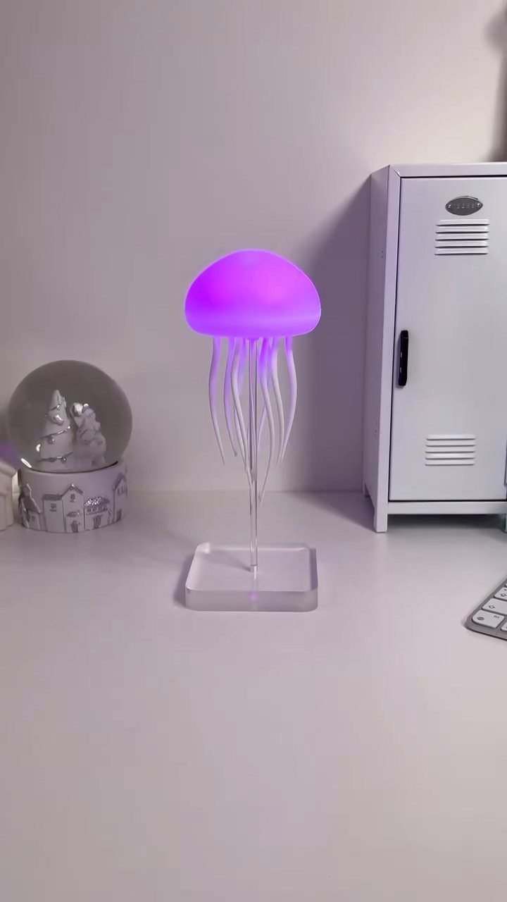 DIY LED Light Lamp Ideas: 27 Backlights, Pendants, Table Lamps 16 Purple glowing jellyfish LED lamp on a white desk next to a locker.
