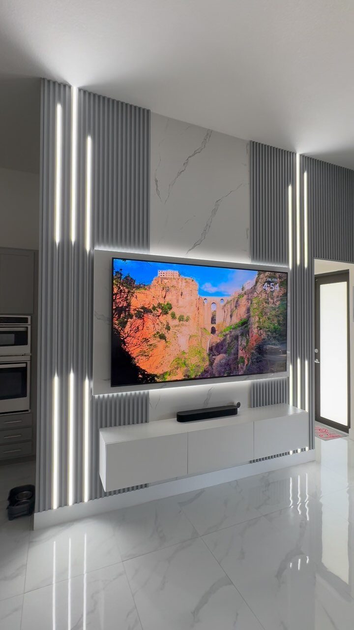 DIY LED Light Lamp Ideas: 27 Backlights, Pendants, Table Lamps 18 Modern living room wall with integrated vertical LED light strips and a television.