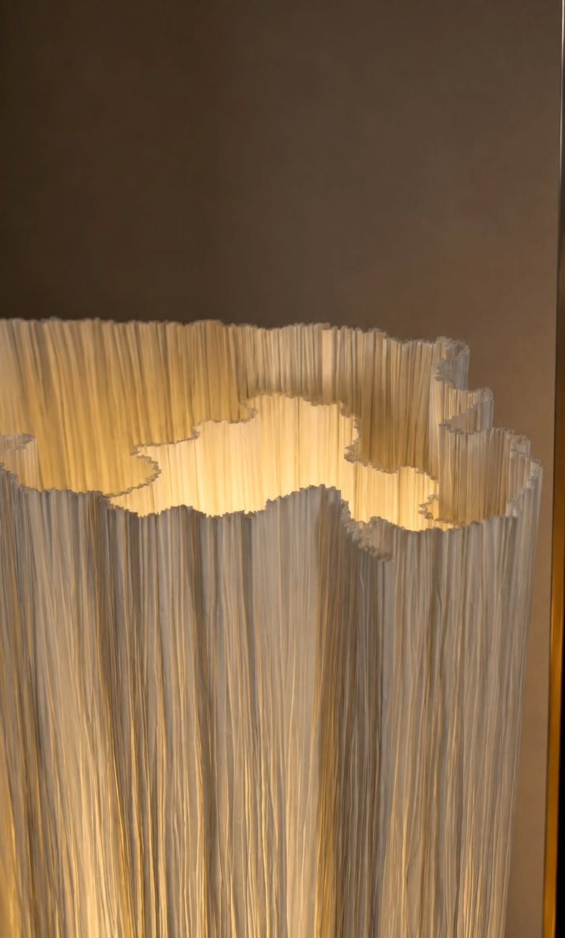 DIY LED Light Lamp Ideas: 27 Backlights, Pendants, Table Lamps 21 White pleated paper lamp shade glowing with warm yellow light from inside.