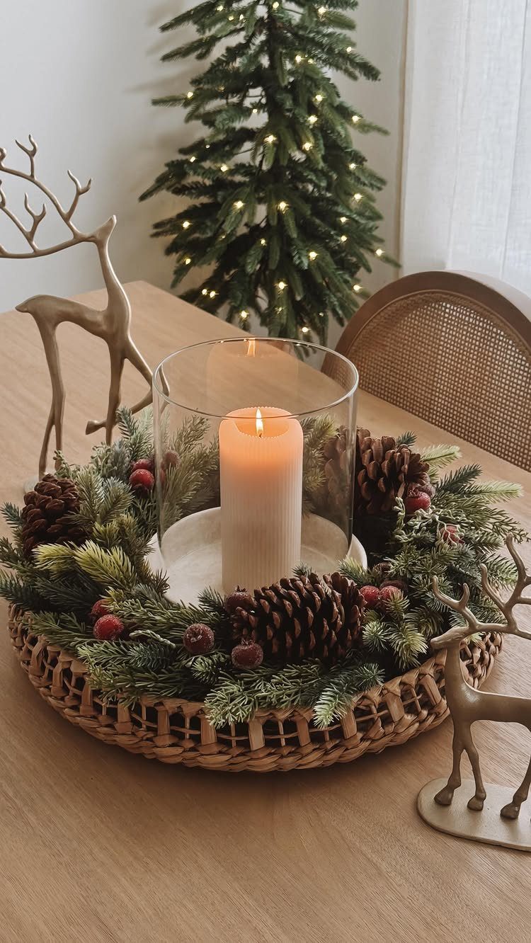Woven tray centerpiece with a lit candle, evergreen wreath, and gold deer figurines.