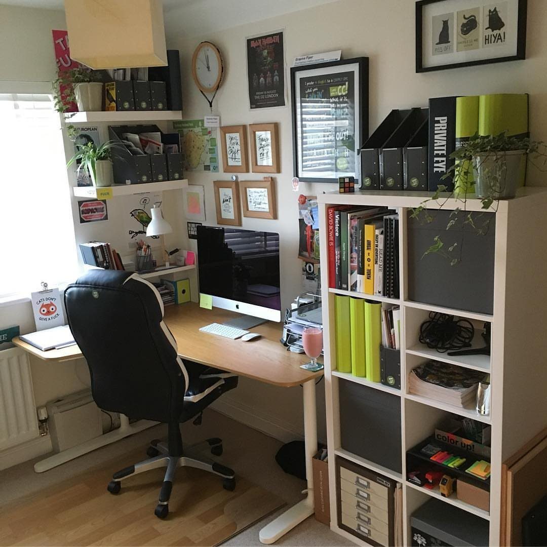 Home office with a light wood desk and white KALLAX cube shelving unit.