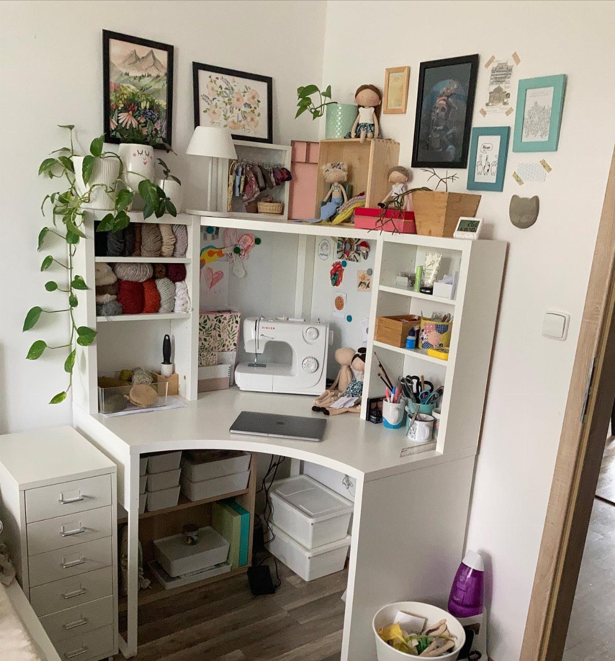White Micke desk with attached bookcase and hutch used as a sewing station.
