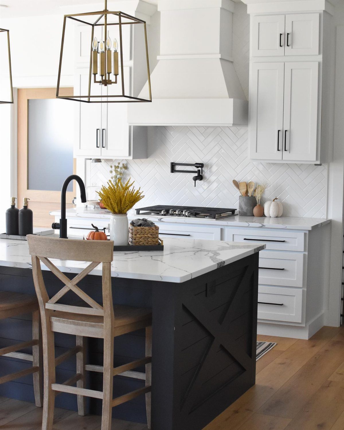 13 Kitchen Island Back Panel Ideas, From Beadboard to Stone 8 Dark navy kitchen island with marble top and X-shaped board and batten paneling.