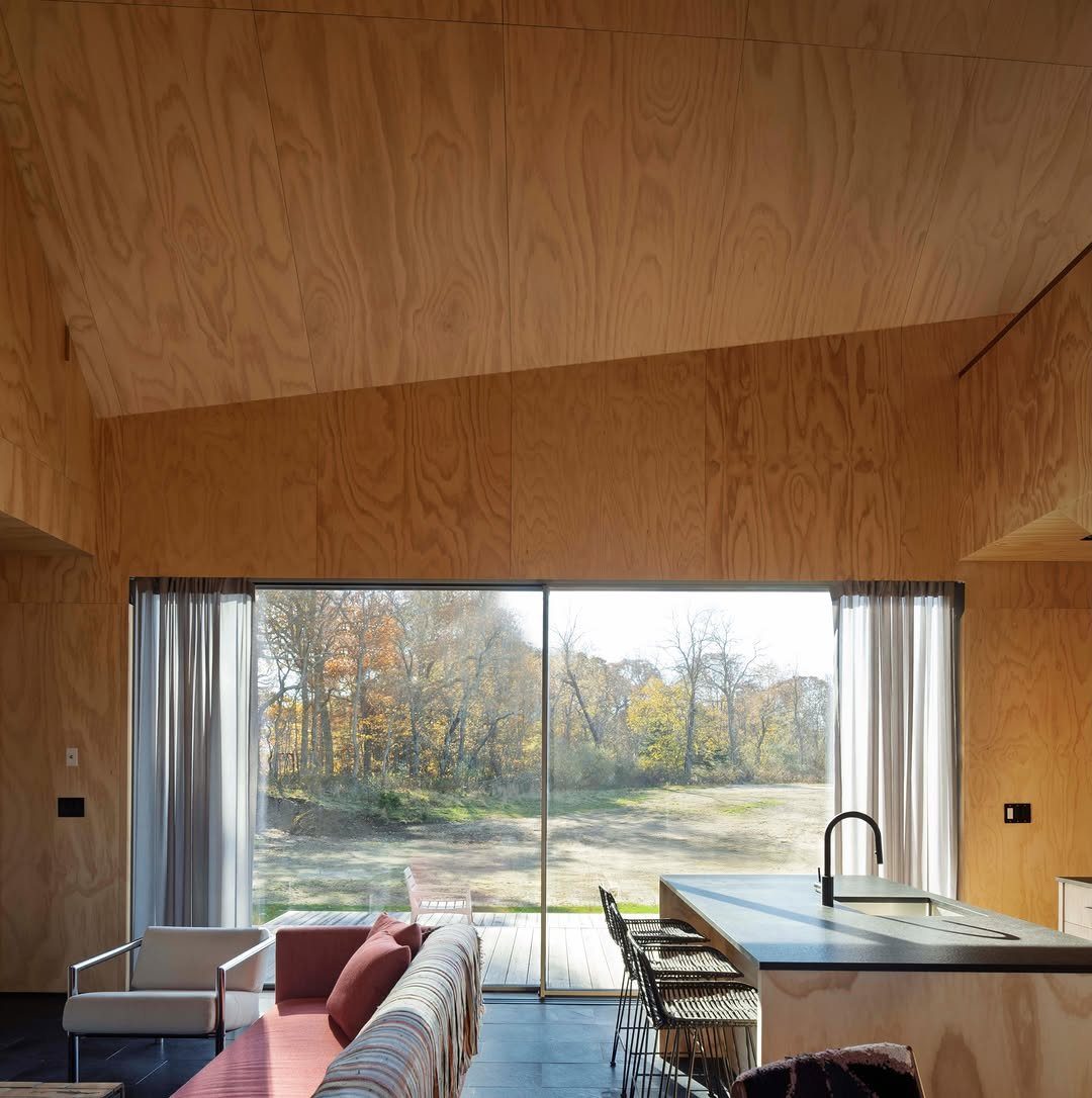 13 Kitchen Island Back Panel Ideas, From Beadboard to Stone 6 Plywood paneled walls and ceiling in a modern kitchen with a large window view.