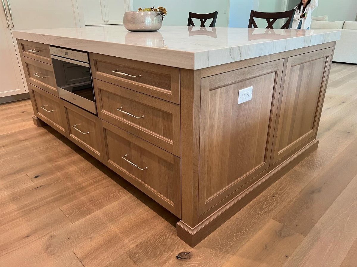 13 Kitchen Island Back Panel Ideas, From Beadboard to Stone 11 Light wood kitchen island with integrated inset panels and white marble countertop