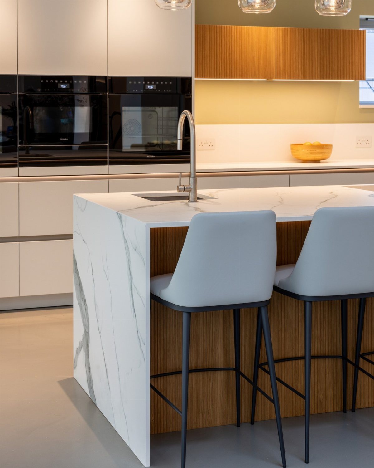 13 Kitchen Island Back Panel Ideas, From Beadboard to Stone 13 Kitchen island with white marble waterfall ends and a natural wood center panel.