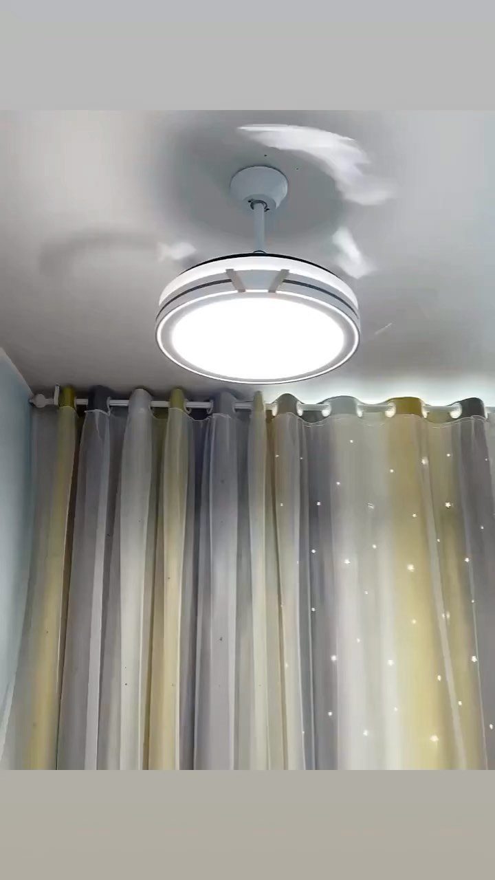 Lights for Room Decoration: 12 Ideas for Every Style in 2026 5 Modern white ceiling fan with a bright circular light fixture and grey curtains.
