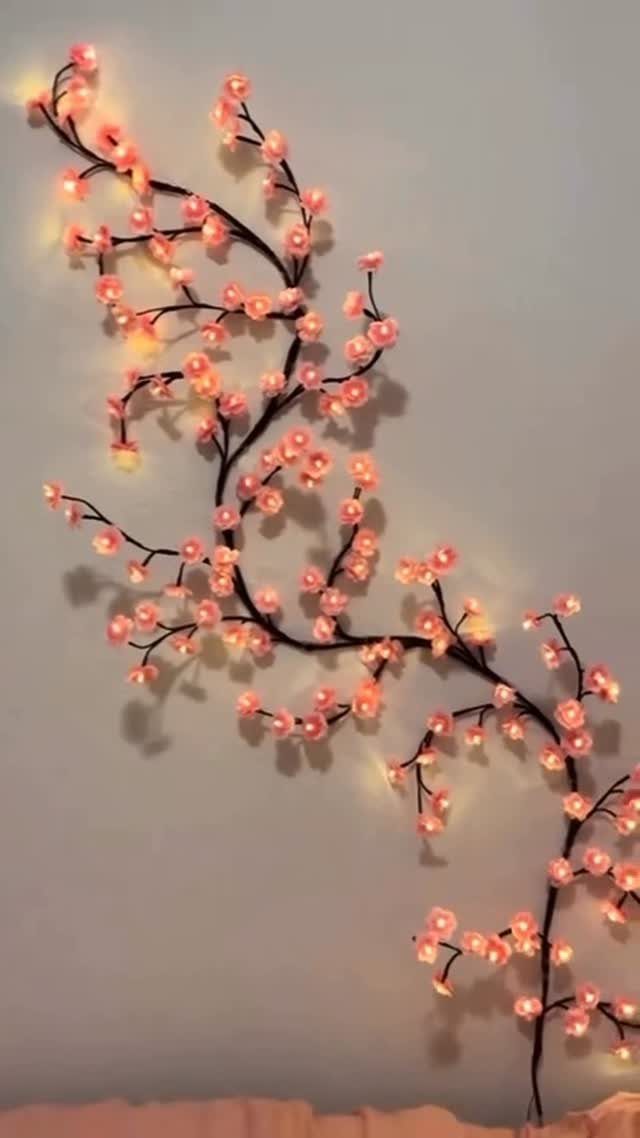 Lights for Room Decoration: 12 Ideas for Every Style in 2026 8 Pink cherry blossom string lights glowing on a grey wall