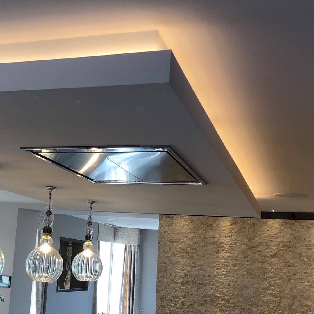Modern Kitchen Hood Ideas: 12 Designs from Metal to Minimalist 11 Flush ceiling range hood recessed into a white dropped ceiling with pendant lights.