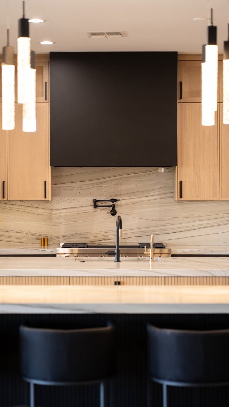 Modern Kitchen Hood Ideas: 12 Designs from Metal to Minimalist 6 Matte black minimalist range hood mounted between light wood kitchen cabinets and marble backsplash.