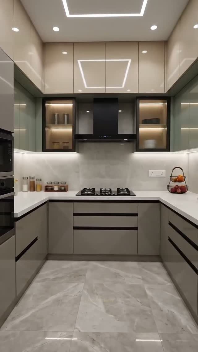 Modern Kitchen Hood Ideas: 12 Designs from Metal to Minimalist 1 Black under-cabinet range hood installed in a modern kitchen with grey and beige cabinetry.