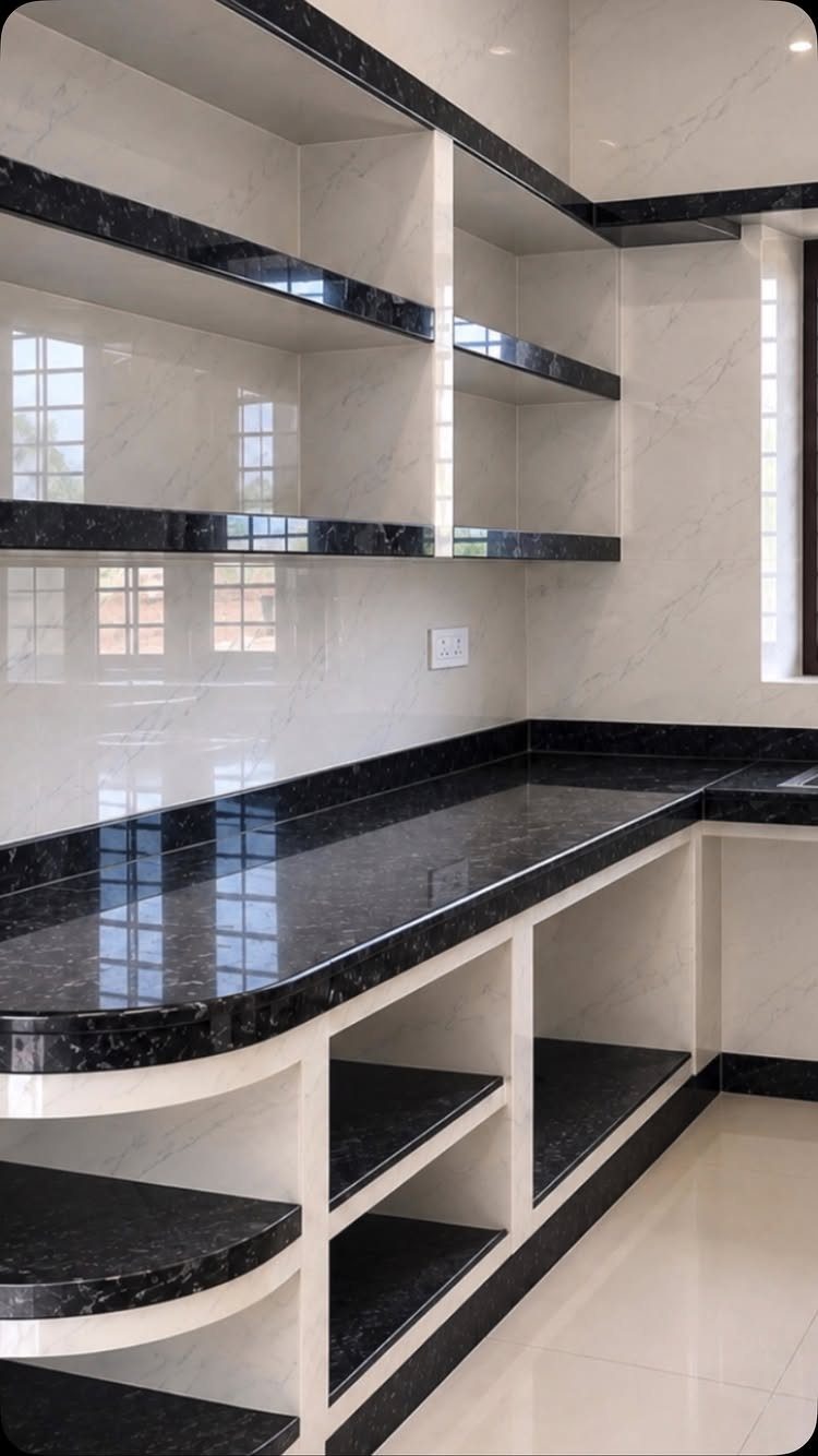 Black marble open shelves and countertops in a bright white modern kitchen
