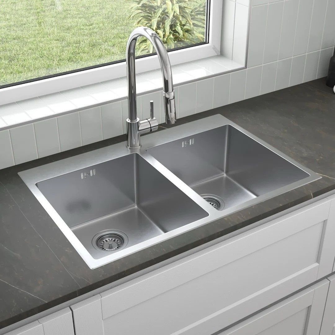 Stainless steel double basin kitchen sink with chrome faucet in dark grey countertop
