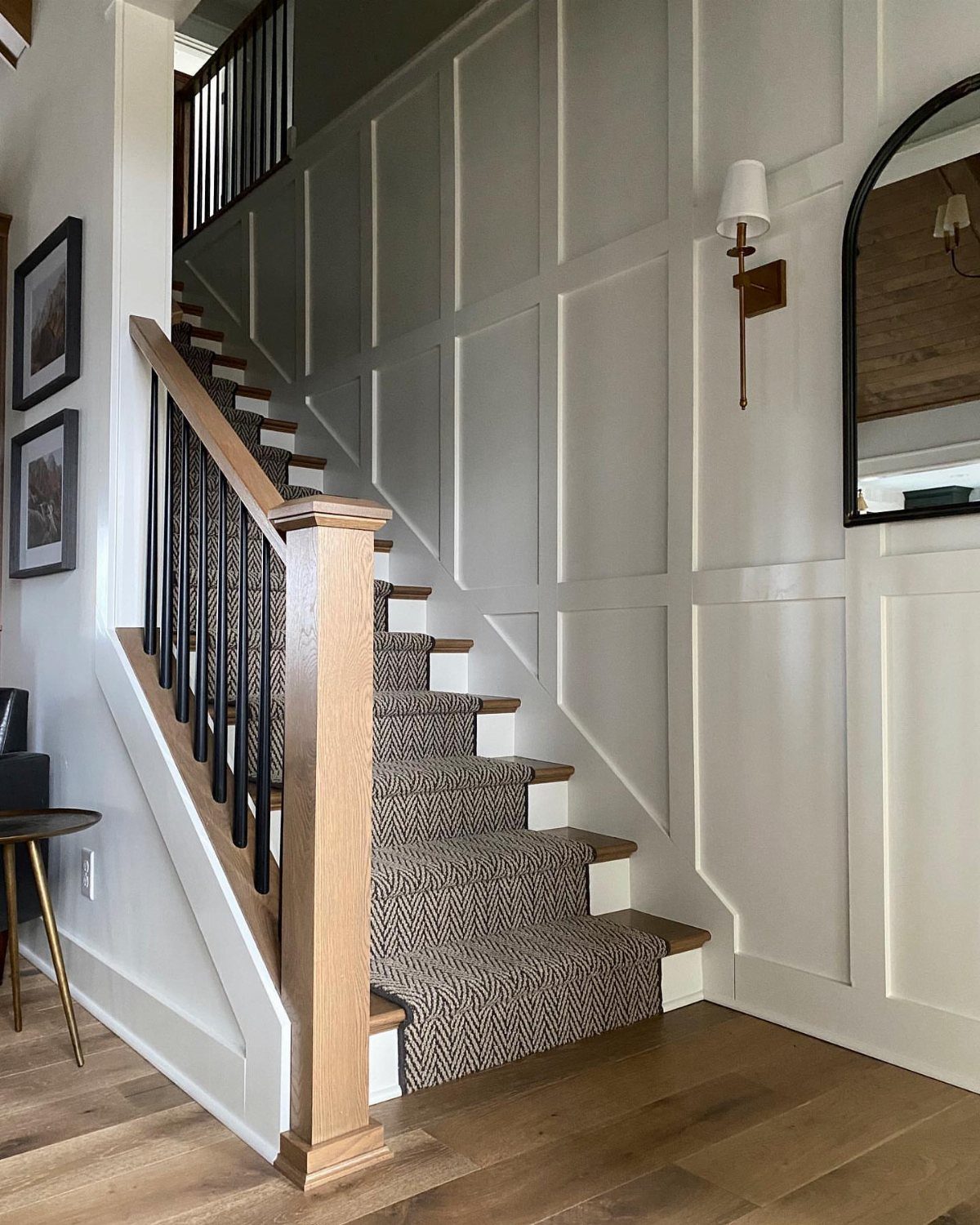 White board and batten grid wall in a stairwell with carpeted steps.