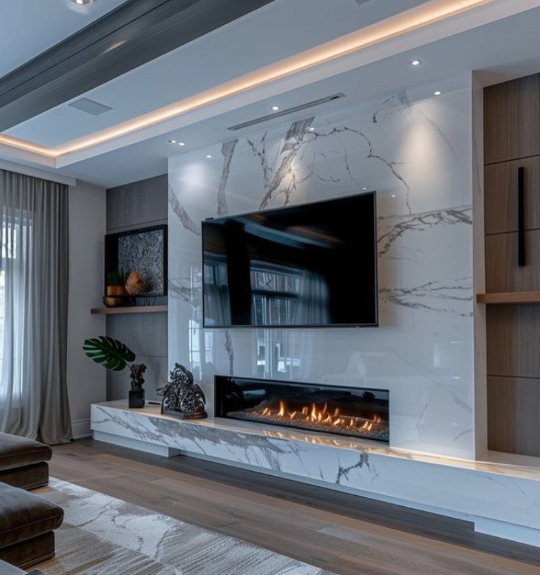 39 TV Design Ideas, from Built-In Shelving to Fireplace Walls 31 Flat-screen TV mounted on a white marble wall above a modern linear fireplace.