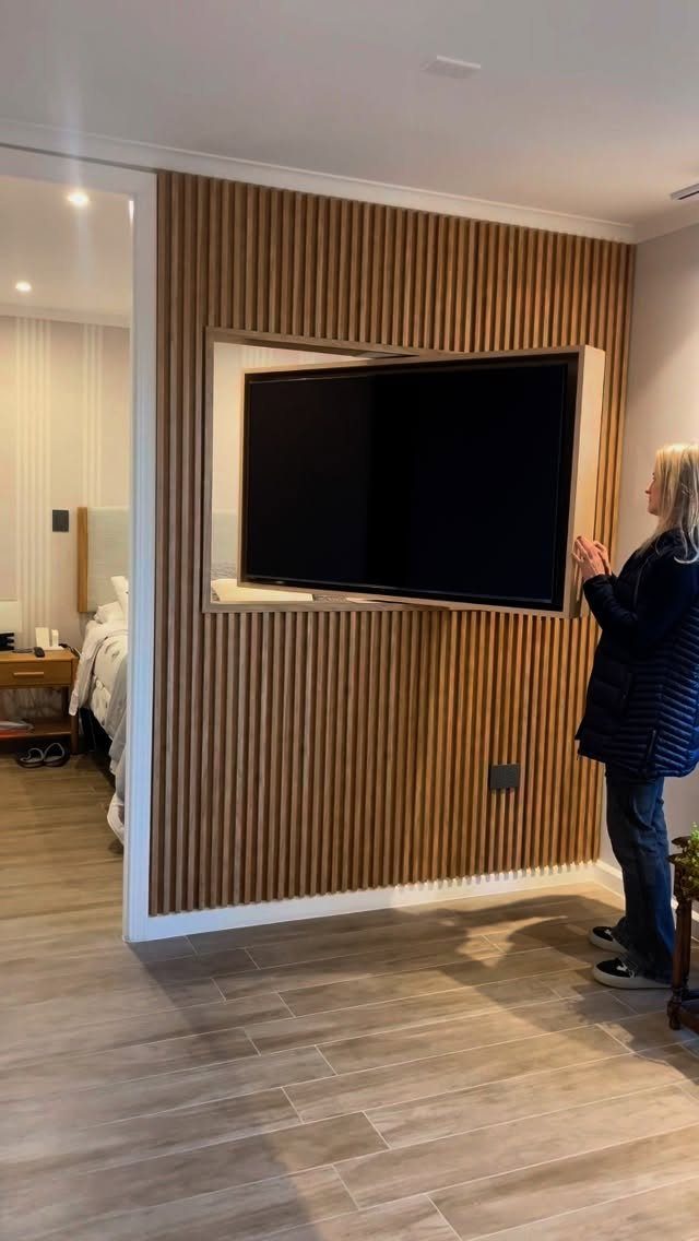 39 TV Design Ideas, from Built-In Shelving to Fireplace Walls 33 Television mounted in a recessed wall niche with vertical wooden slat paneling
