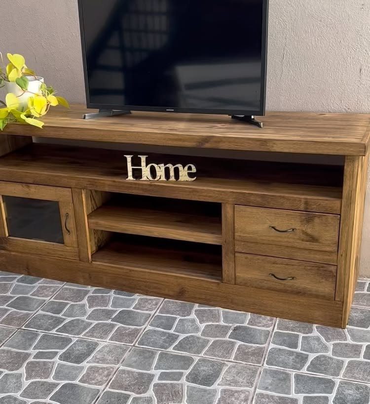 39 TV Design Ideas, from Built-In Shelving to Fireplace Walls 38 Black television on a rustic brown wooden entertainment center with a Home sign.