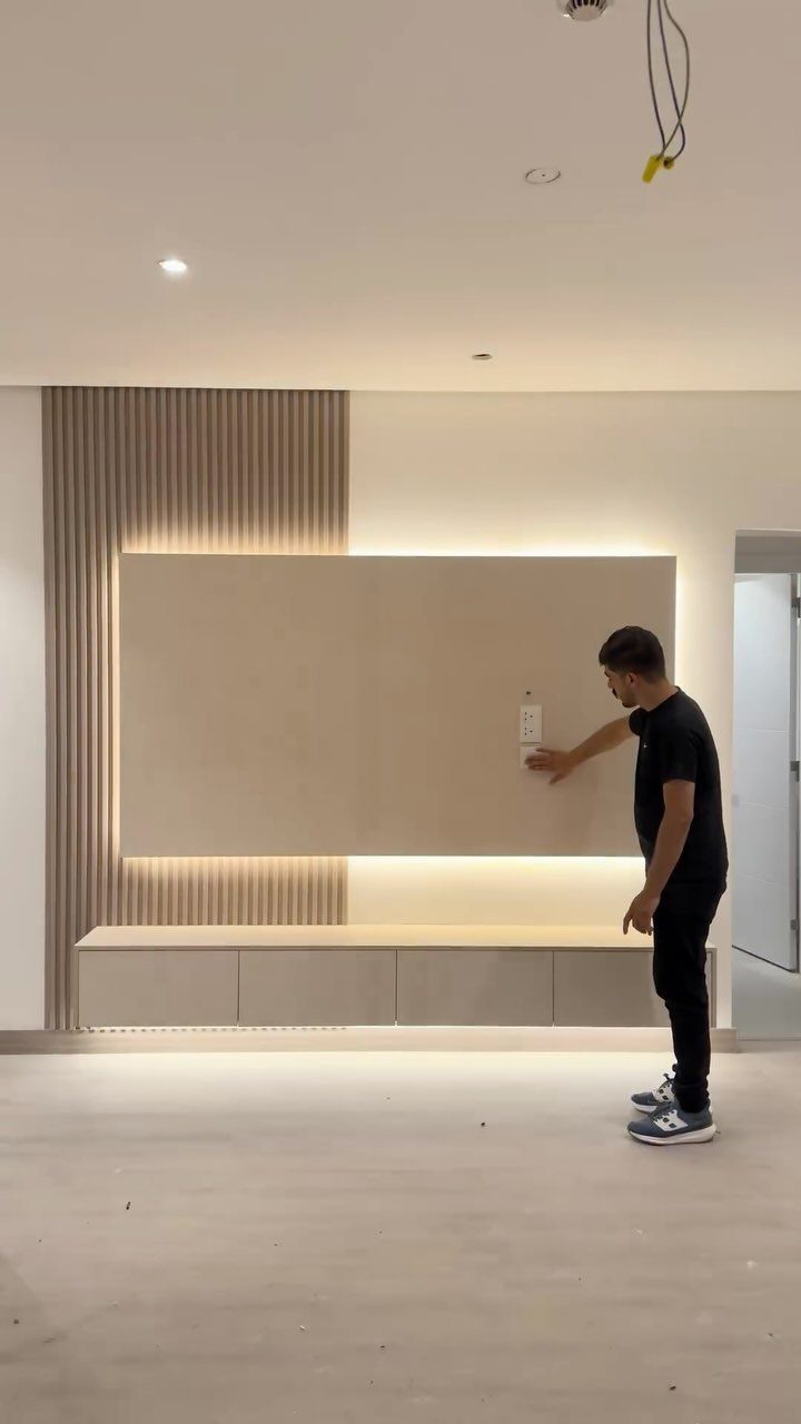 39 TV Design Ideas, from Built-In Shelving to Fireplace Walls 25 Modern TV unit with vertical wooden acoustic panels and a backlit wall panel.