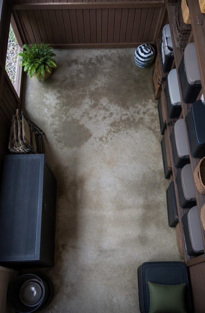 A storage area under a deck with skirting material for accessibility.