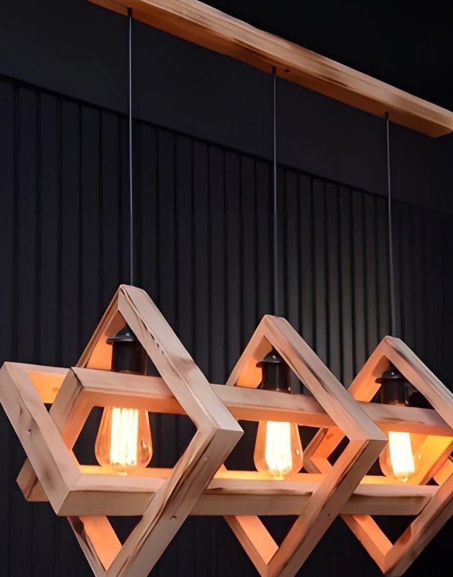 Three diamond-shaped wooden pendant lamps hanging from a wooden ceiling beam.
