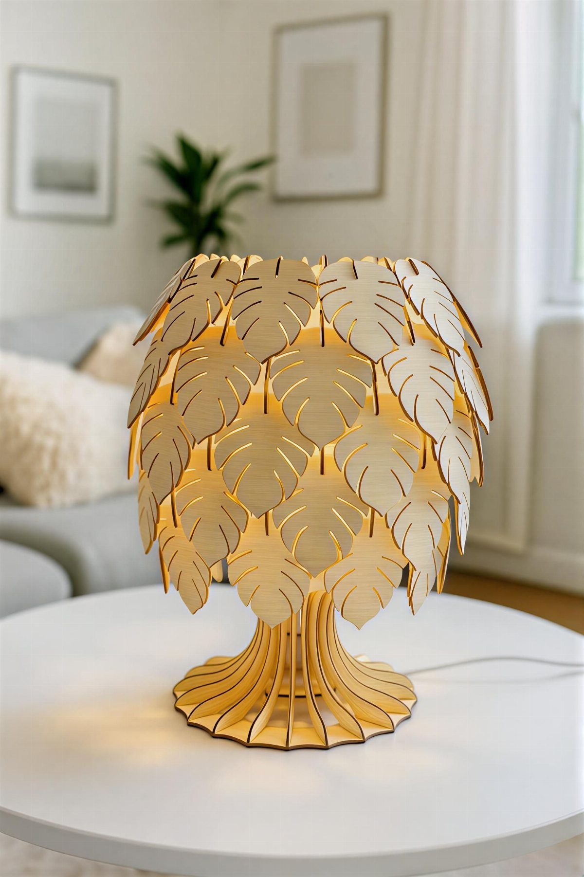 Wooden table lamp with leaf-shaped cutouts emitting a warm glow on a white table.