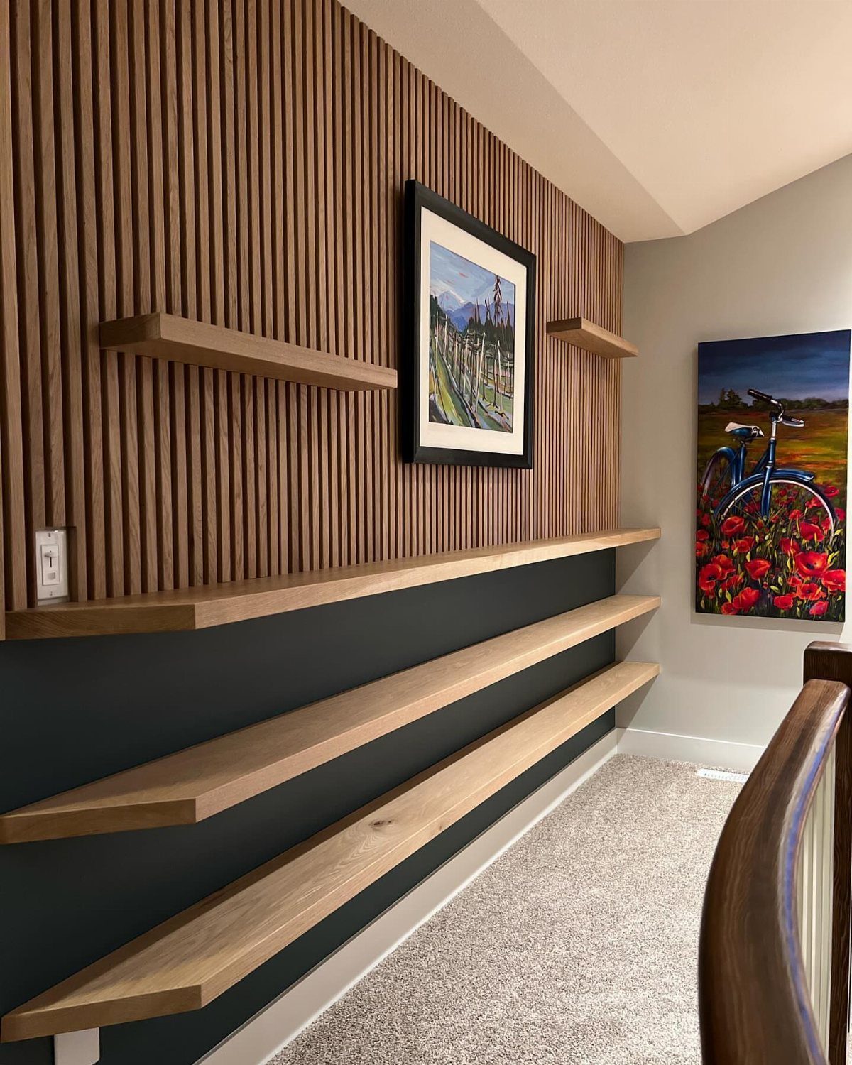 Wood Slat Wall with Shelves: 10 Ideas for Plants, TVs, Desks 7 Light wood floating shelves mounted on a dark grey wall with a slat wall above.